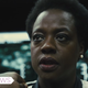 Amanda Waller stares at an out-of-frame Bloodsport, who's threatening to kill her with a pen.